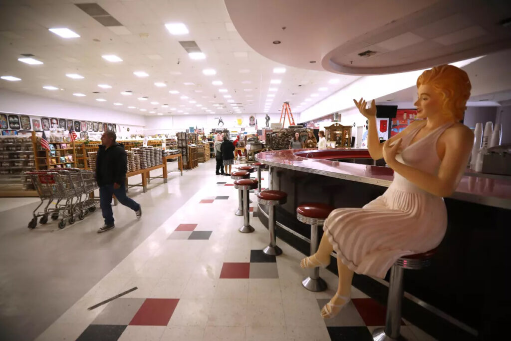 A figure of Marilyn Monroe sits on a stool as shoppers visit Blackwell’s Corner in January 2024. (Genaro Molina / Los Angeles Times)