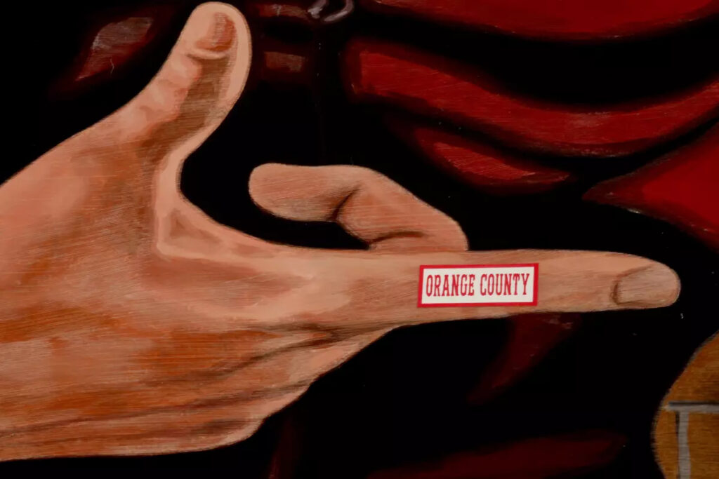 Someone added “Orange County” to the forefinger of a gigantic wood-paneled image of actor James Dean. (Genaro Molina / Los Angeles Times)